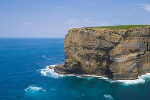 Seaside Majesty Breathtaking Coastal Cliffs Meet Stunning Blue Sea, A Spectacle of Nature's Grandeur photo