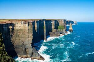 Seaside Majesty Breathtaking Coastal Cliffs Meet Stunning Blue Sea, A Spectacle of Nature's Grandeur photo