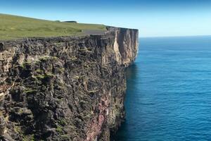 Seaside Majesty Breathtaking Coastal Cliffs Meet Stunning Blue Sea, A Spectacle of Nature's Grandeur photo