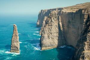 Seaside Majesty Breathtaking Coastal Cliffs Meet Stunning Blue Sea, A Spectacle of Nature's Grandeur photo