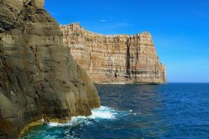 Seaside Majesty Breathtaking Coastal Cliffs Meet Stunning Blue Sea, A Spectacle of Nature's Grandeur photo