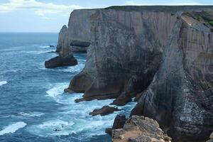 Seaside Majesty Breathtaking Coastal Cliffs Meet Stunning Blue Sea, A Spectacle of Nature's Grandeur photo