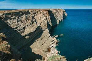 Seaside Majesty Breathtaking Coastal Cliffs Meet Stunning Blue Sea, A Spectacle of Nature's Grandeur photo