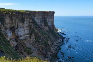 Seaside Majesty Breathtaking Coastal Cliffs Meet Stunning Blue Sea, A Spectacle of Nature's Grandeur photo