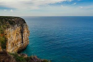 Seaside Majesty Breathtaking Coastal Cliffs Meet Stunning Blue Sea, A Spectacle of Nature's Grandeur photo