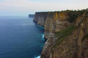 Seaside Majesty Breathtaking Coastal Cliffs Meet Stunning Blue Sea, A Spectacle of Nature's Grandeur photo