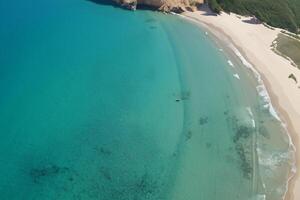 Horizon Haven Aerial Serenity Captures Beautiful Beach Sand from Above, a Tranquil Tapestry of Coastal Beauty photo