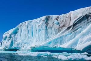 Majestic Ice Cliffs Crowned by a Cool Atmosphere, Framed by the Beautiful Sea and Sky, Conjuring a Harmonious Panorama of Nature's Icy Grandeur and Oceanic Splendor photo