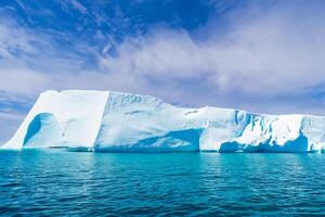 Majestic Ice Cliffs Crowned by a Cool Atmosphere, Framed by the Beautiful Sea and Sky, Conjuring a Harmonious Panorama of Nature's Icy Grandeur and Oceanic Splendor photo