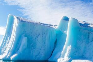 Majestic Ice Cliffs Crowned by a Cool Atmosphere, Framed by the Beautiful Sea and Sky, Conjuring a Harmonious Panorama of Nature's Icy Grandeur and Oceanic Splendor photo