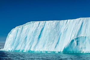 Majestic Ice Cliffs Crowned by a Cool Atmosphere, Framed by the Beautiful Sea and Sky, Conjuring a Harmonious Panorama of Nature's Icy Grandeur and Oceanic Splendor photo