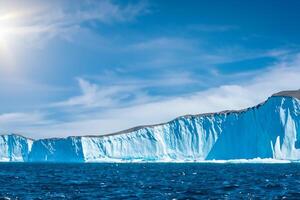 Majestic Ice Cliffs Crowned by a Cool Atmosphere, Framed by the Beautiful Sea and Sky, Conjuring a Harmonious Panorama of Nature's Icy Grandeur and Oceanic Splendor photo