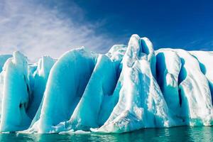 Majestic Ice Cliffs Crowned by a Cool Atmosphere, Framed by the Beautiful Sea and Sky, Conjuring a Harmonious Panorama of Nature's Icy Grandeur and Oceanic Splendor photo