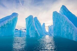 Majestic Ice Cliffs Crowned by a Cool Atmosphere, Framed by the Beautiful Sea and Sky, Conjuring a Harmonious Panorama of Nature's Icy Grandeur and Oceanic Splendor photo