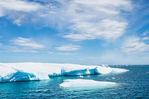 Majestic Ice Cliffs Crowned by a Cool Atmosphere, Framed by the Beautiful Sea and Sky, Conjuring a Harmonious Panorama of Nature's Icy Grandeur and Oceanic Splendor photo