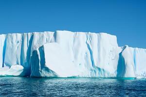 Majestic Ice Cliffs Crowned by a Cool Atmosphere, Framed by the Beautiful Sea and Sky, Conjuring a Harmonious Panorama of Nature's Icy Grandeur and Oceanic Splendor photo