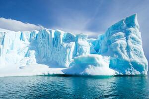 Majestic Ice Cliffs Crowned by a Cool Atmosphere, Framed by the Beautiful Sea and Sky, Conjuring a Harmonious Panorama of Nature's Icy Grandeur and Oceanic Splendor photo