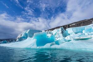 Majestic Ice Cliffs Crowned by a Cool Atmosphere, Framed by the Beautiful Sea and Sky, Conjuring a Harmonious Panorama of Nature's Icy Grandeur and Oceanic Splendor photo