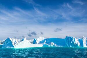 Majestic Ice Cliffs Crowned by a Cool Atmosphere, Framed by the Beautiful Sea and Sky, Conjuring a Harmonious Panorama of Nature's Icy Grandeur and Oceanic Splendor photo