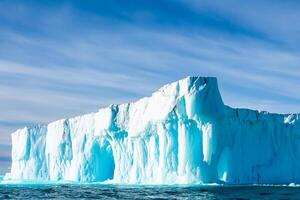 Majestic Ice Cliffs Crowned by a Cool Atmosphere, Framed by the Beautiful Sea and Sky, Conjuring a Harmonious Panorama of Nature's Icy Grandeur and Oceanic Splendor photo