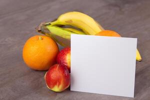 Card and White Paper Mockup Harmonized with Fresh Fruit, Crafting a Visual Symphony of Artful Design and Culinary Delight, Where Wholesome Ingredients Merge in a Feast of Vibrant Imagery photo