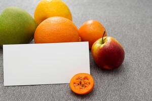 Card and White Paper Mockup Harmonized with Fresh Fruit, Crafting a Visual Symphony of Artful Design and Culinary Delight, Where Wholesome Ingredients Merge in a Feast of Vibrant Imagery photo