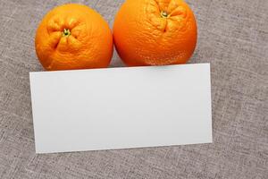 Generated imageWhite Paper Mockup Enlivened by the Zesty Aura of Fresh Oranges, Crafting a Visual Symphony of Culinary Opulence and Wholesome Design photo