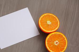 Generated imageWhite Paper Mockup Enlivened by the Zesty Aura of Fresh Oranges, Crafting a Visual Symphony of Culinary Opulence and Wholesome Design photo