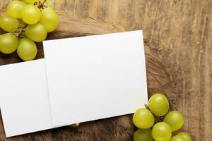 White Paper Mockup Enhanced by the Juicy Allure of Fresh Grapes, Crafting a Visual Symphony of Culinary Elegance and Wholesome Imagery, Where Graphic Design Flourishes in a Feast of Vibrant Creativity photo