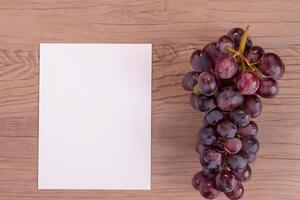 White Paper Mockup Enhanced by the Juicy Allure of Fresh Grapes, Crafting a Visual Symphony of Culinary Elegance and Wholesome Imagery, Where Graphic Design Flourishes in a Feast of Vibrant Creativity photo