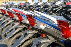 New motorcycles parked in a row on the sidewalk, transportation background photo