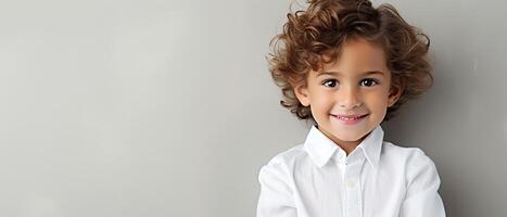 Smiling youngster, plain background, lively expression, ample right margin for copy photo