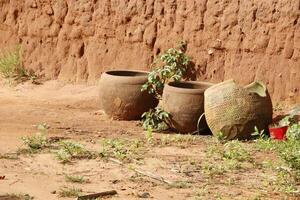 handmade potterie against a mudhouse photo