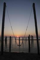 sunset, swing set, pole village in the netherlands photo