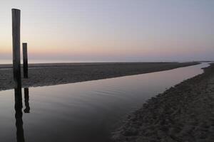 sunset in the pole village of Petten in the Netherlands photo