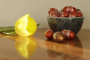 bowl with chocolate easter eggs and yellow tulip photo