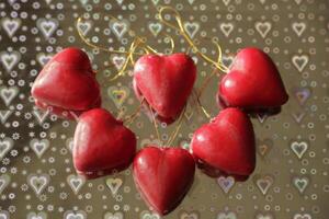 red hearts on a silver background with hearts photo