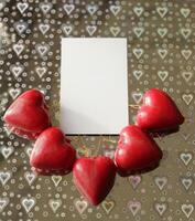 red hearts on a silver background with hearts photo