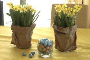 paper bag with daffodils and easter eggs photo