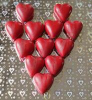 red hearts on a silver background with hearts photo