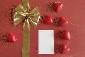 bow in a gold ribbon on a red background, valentines day wishes photo