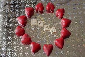 red hearts on a silver background with hearts photo