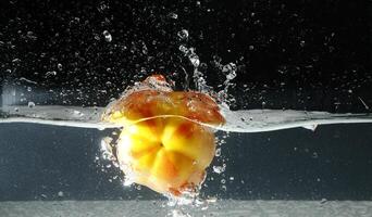 splashing bellpepper in water photo