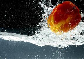 splashing bellpepper in water photo