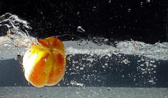 splashing bellpepper in water photo