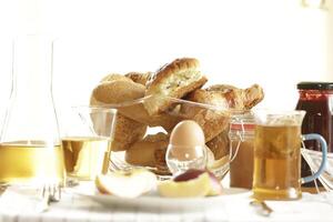 continental breakfast with tea, juice, bread and egg photo