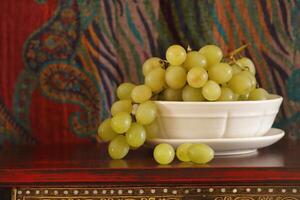 white fruit bowl with grapes photo