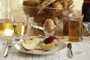 continental breakfast with tea, juice, bread and egg photo