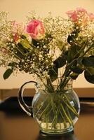 a glass vase with bouquet with pink and white flowers photo
