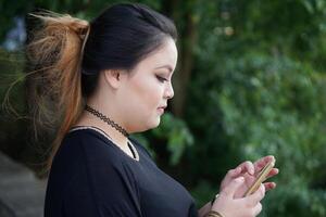 young asian woman texting with smartphone photo